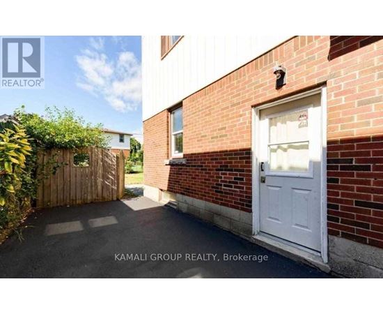 A white door is on the brick building.
