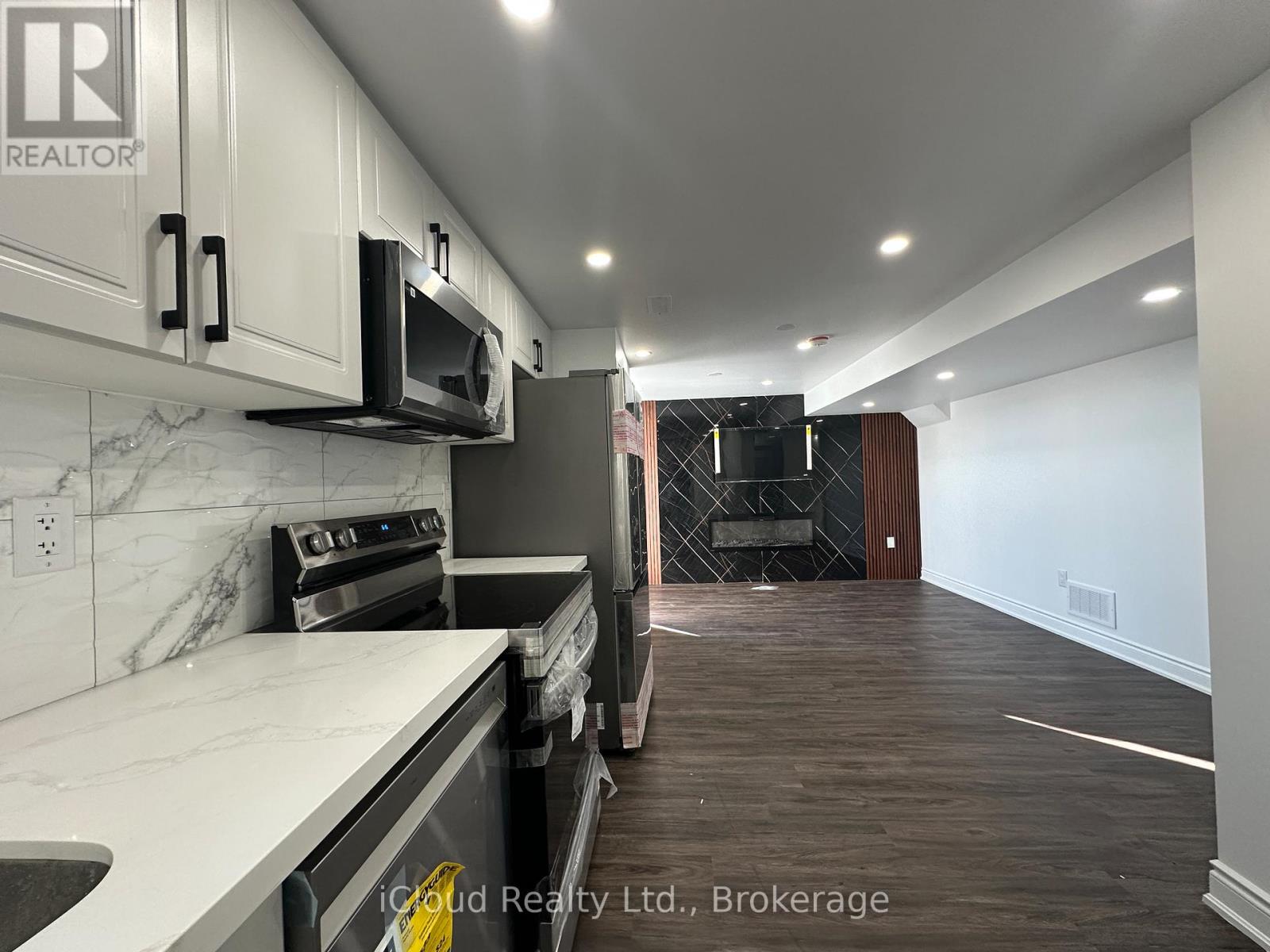 A kitchen with white cabinets and a black stove top oven.