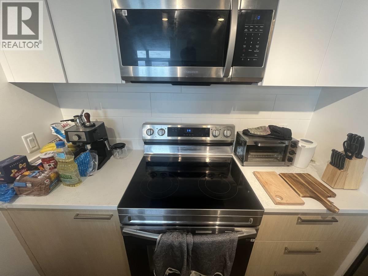 A kitchen with a stove top oven and microwave above it.