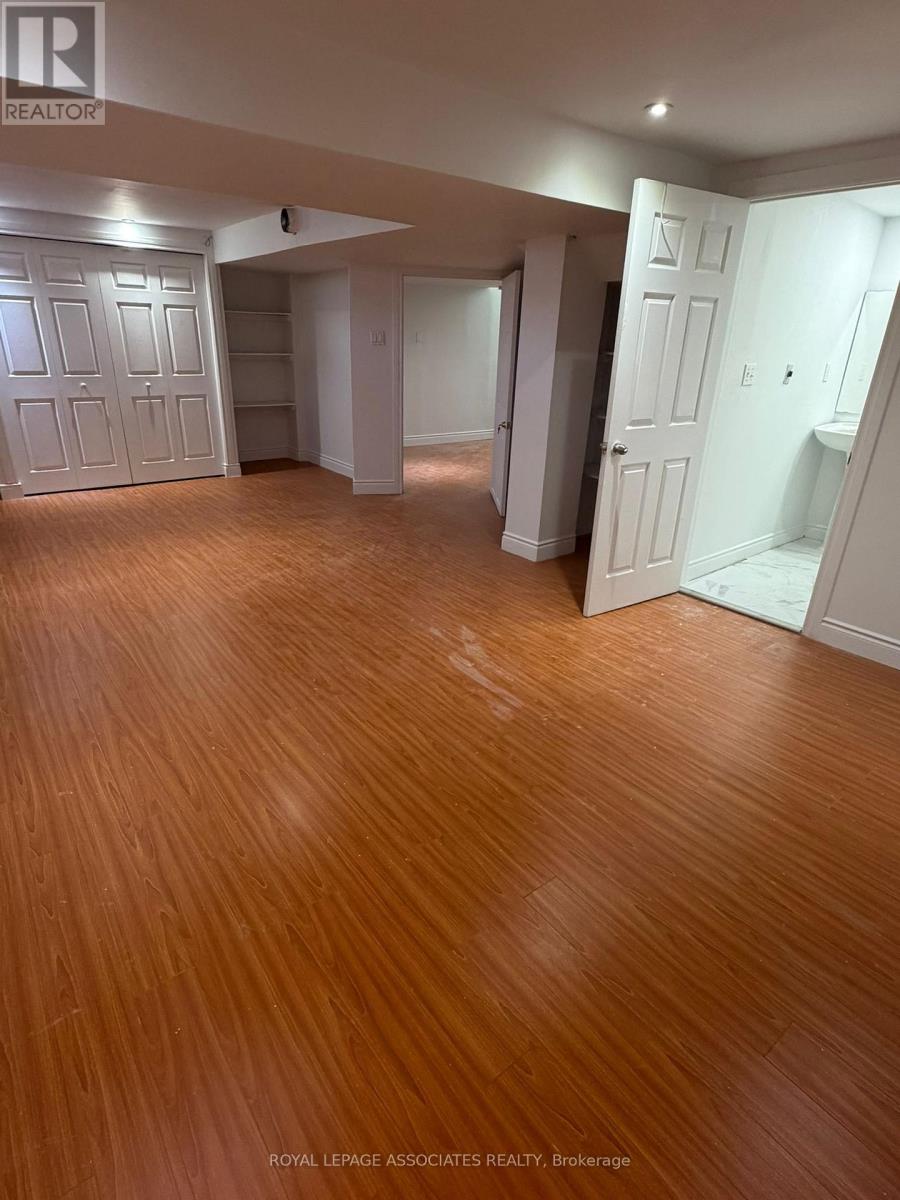 A room with wooden flooring and white walls.