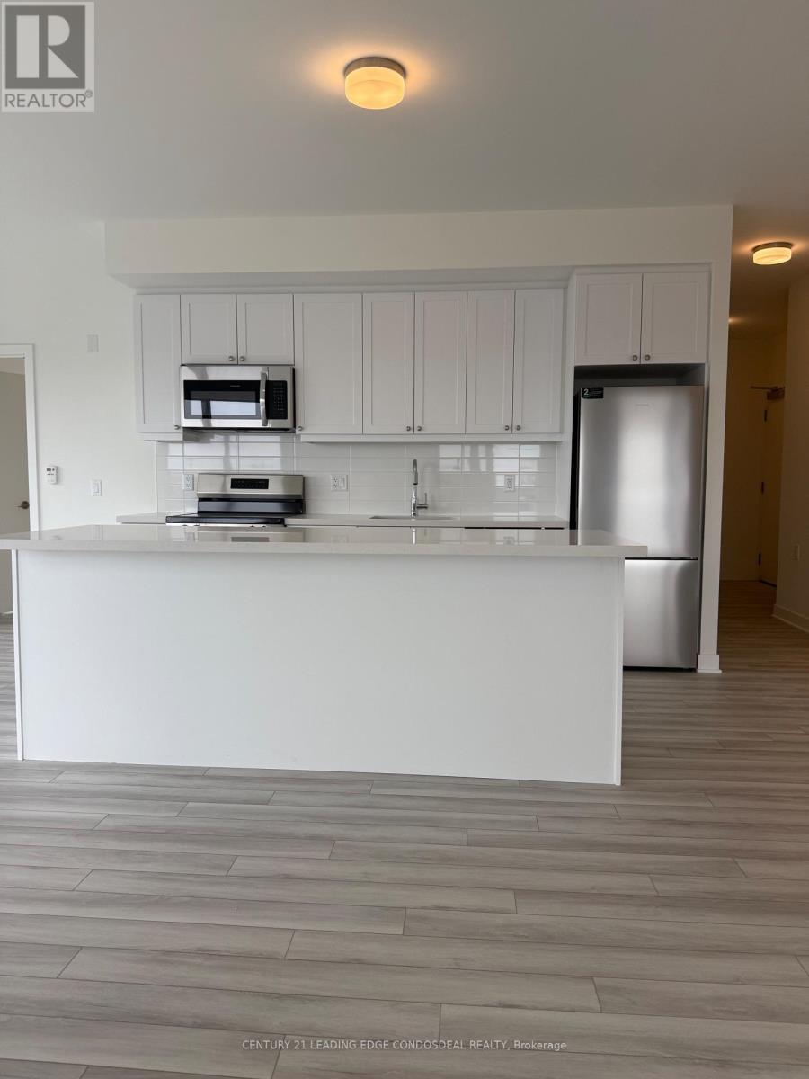 A modern kitchen with white cabinets and a large island.
