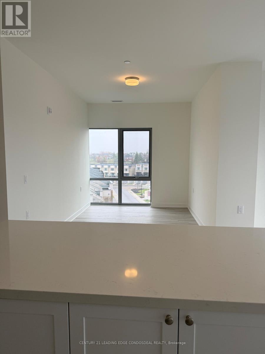 A real estate listing photo of a white interior space with a large window.