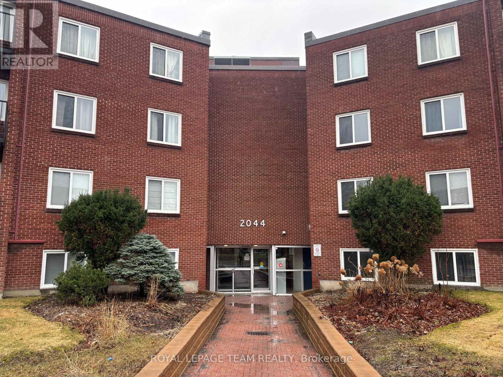 A red brick building with the number 2044 on the front.