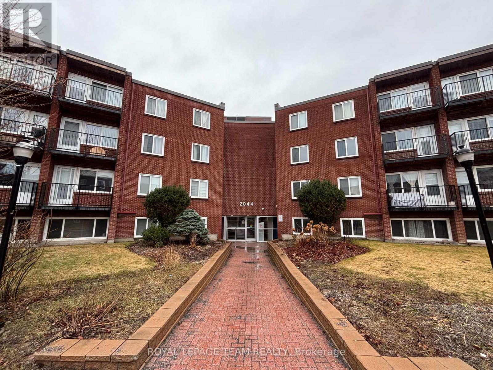 A brick building with a walkway in front of it.