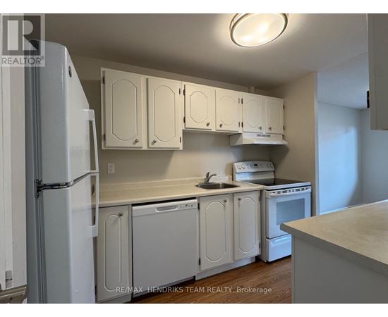 A kitchen with white cabinets and appliances.