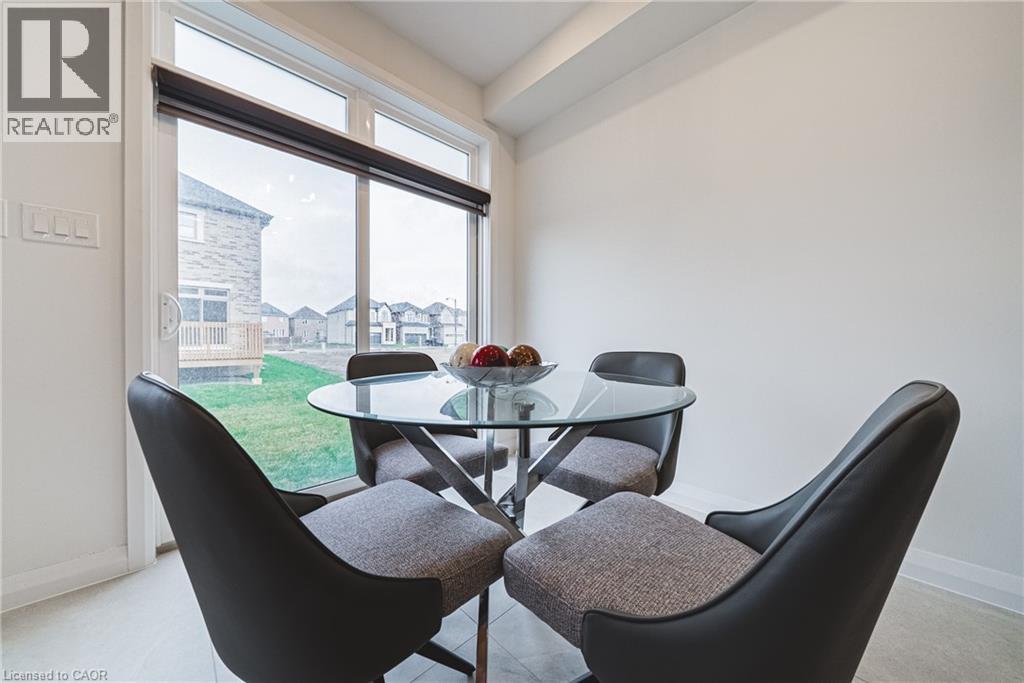 A dining room with a glass table and chairs.