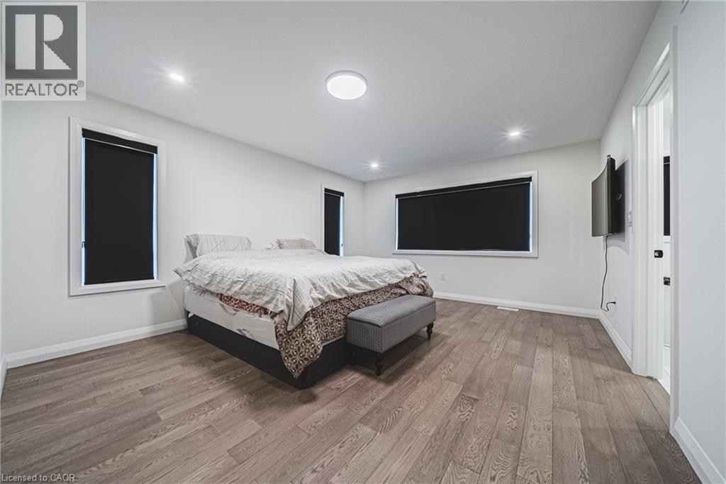A bedroom with a bed, a bench, and a television.