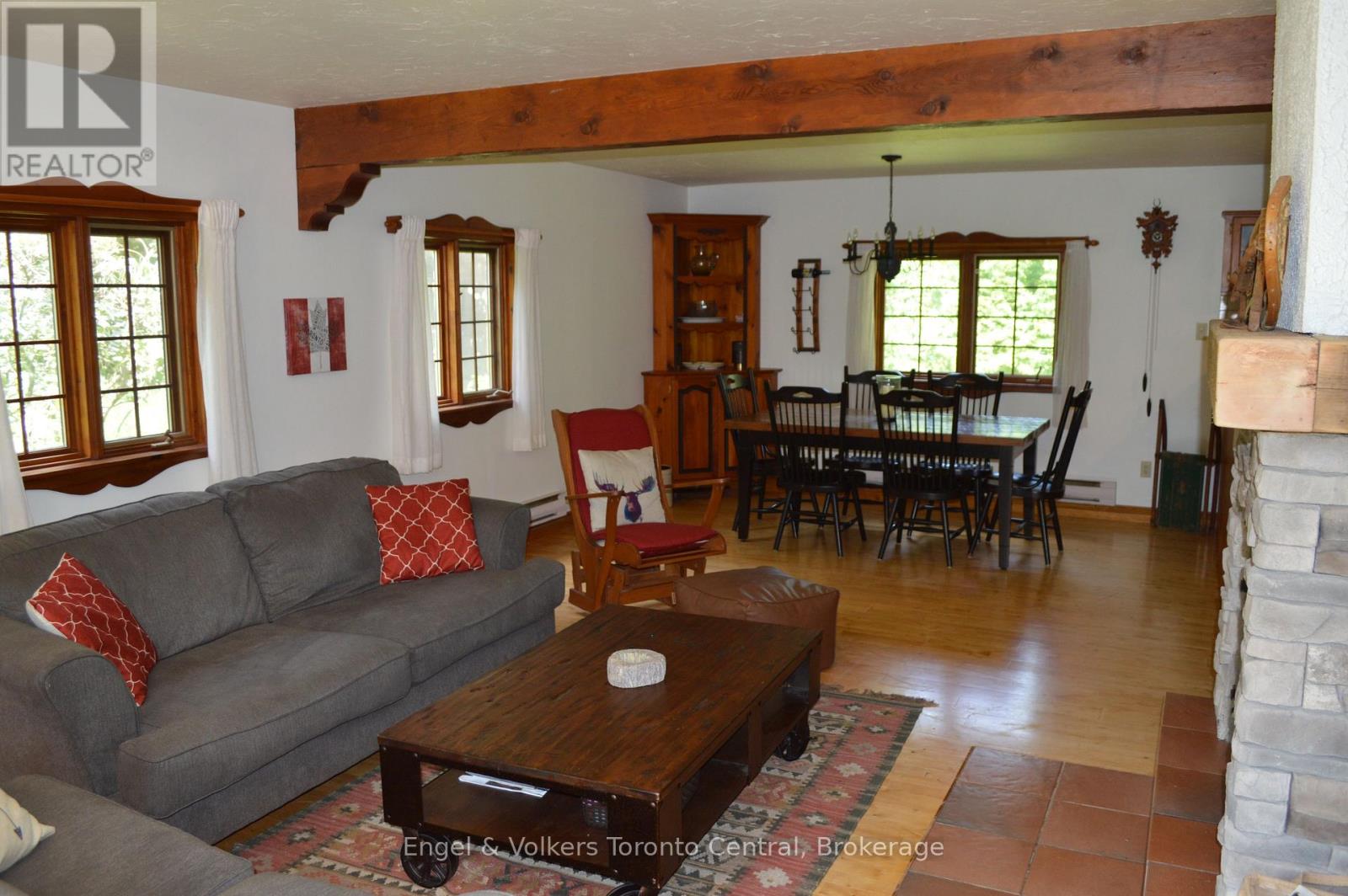 A living room with a grey couch and a wooden coffee table.