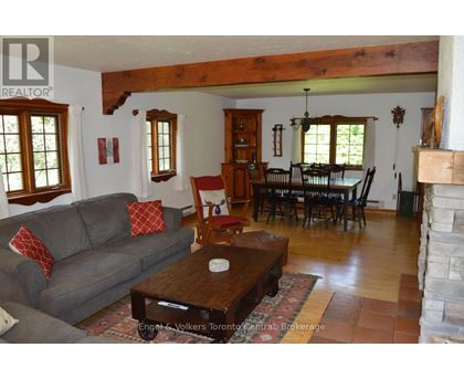A living room with a grey couch and a wooden coffee table.