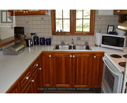 A kitchen with wooden cabinets and a white countertop.