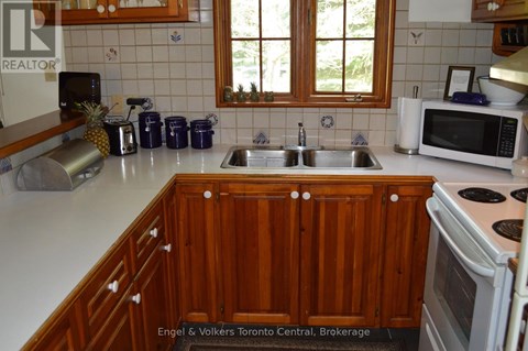 A kitchen with wooden cabinets and a white countertop.