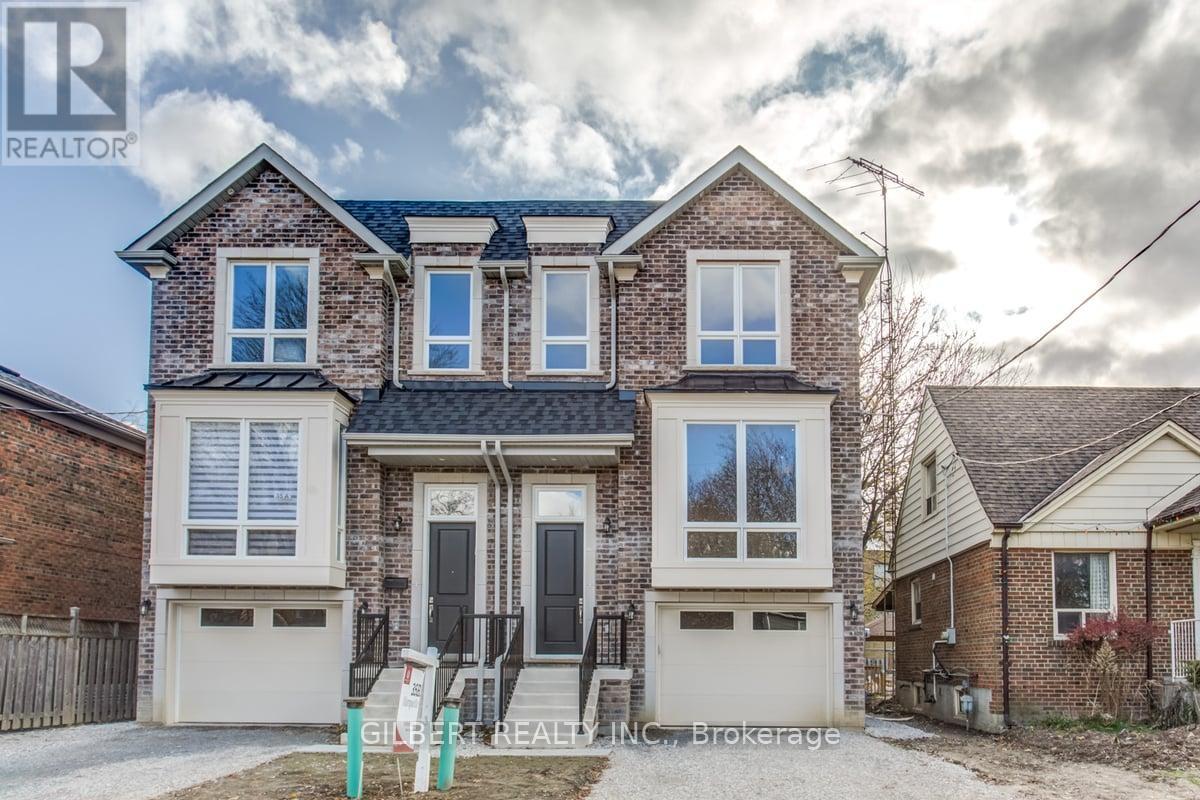 A two-story house with a brick facade and white trim is for sale.