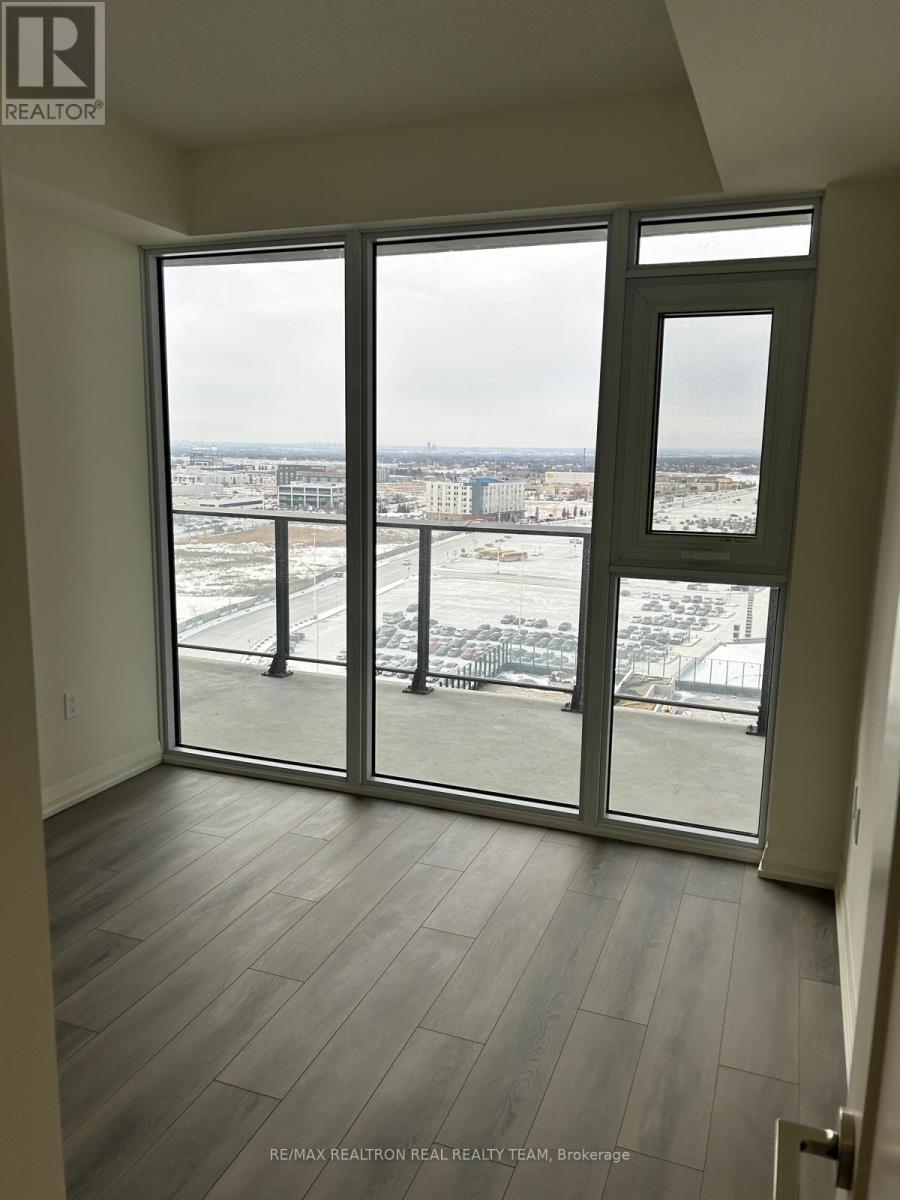 A room with a view of the city through large windows.
