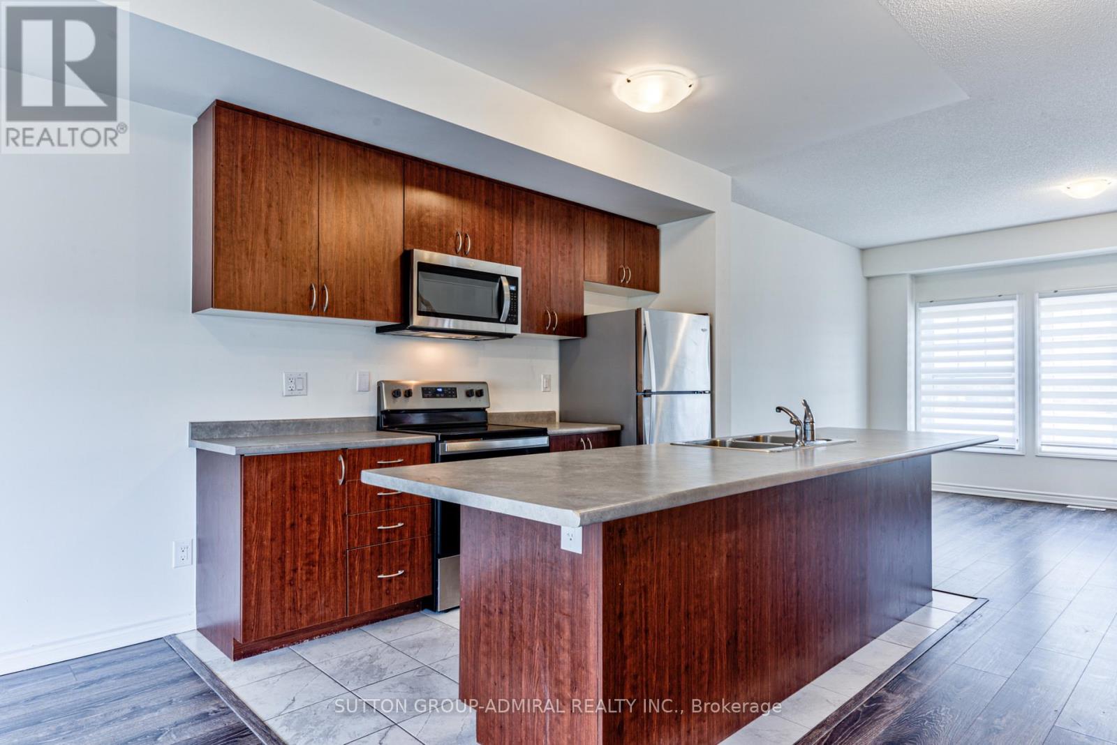 A kitchen with wooden cabinets and a granite countertop.
