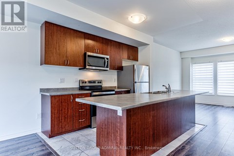 A kitchen with wooden cabinets and a granite countertop.