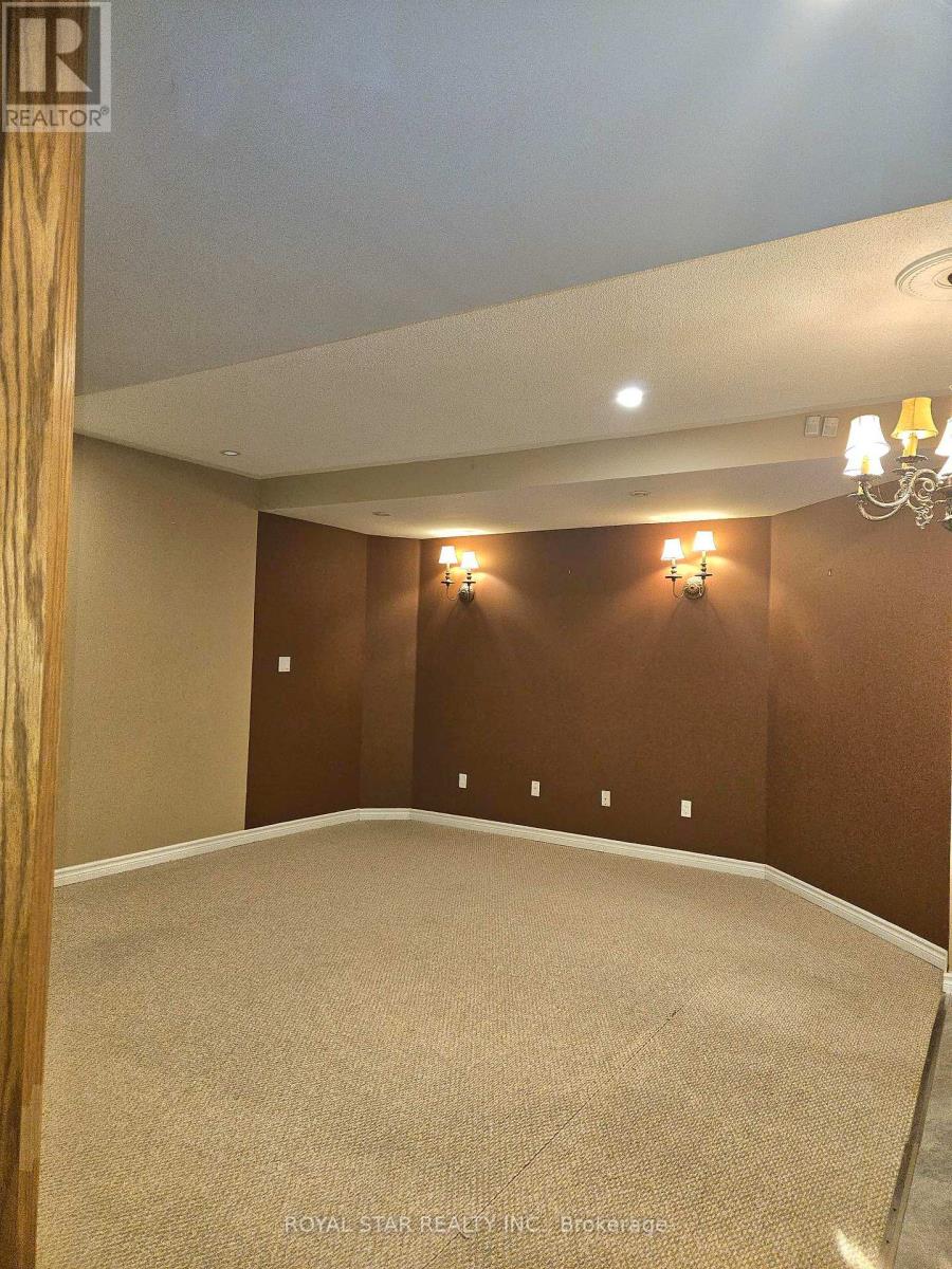 A room with a carpet floor and a chandelier hanging from the ceiling.