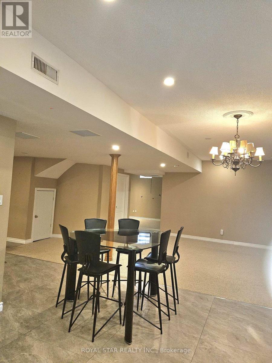 A dining room with a table and chairs.