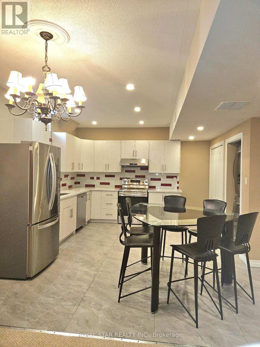 A modern kitchen with a dining table and chairs.