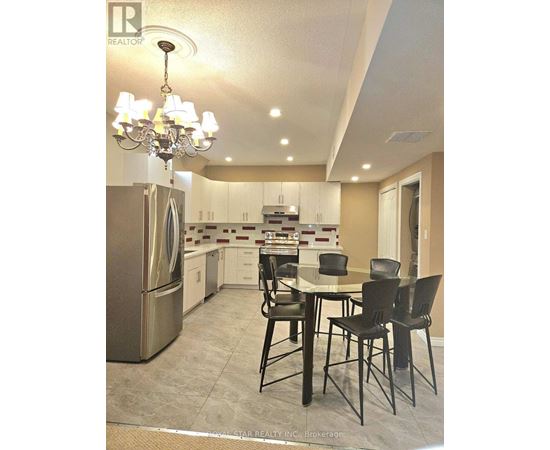 A modern kitchen with a dining table and chairs.
