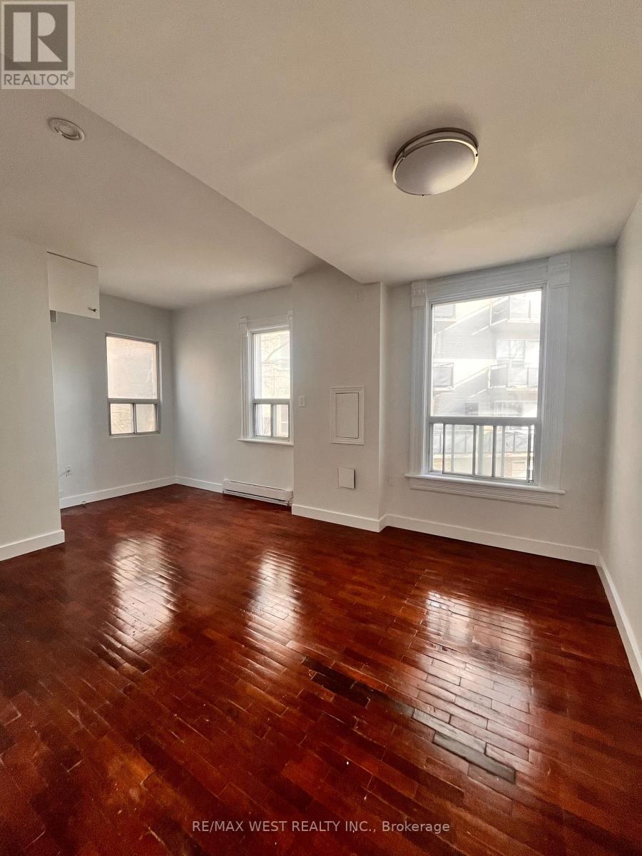 A room with wooden floors and white walls.
