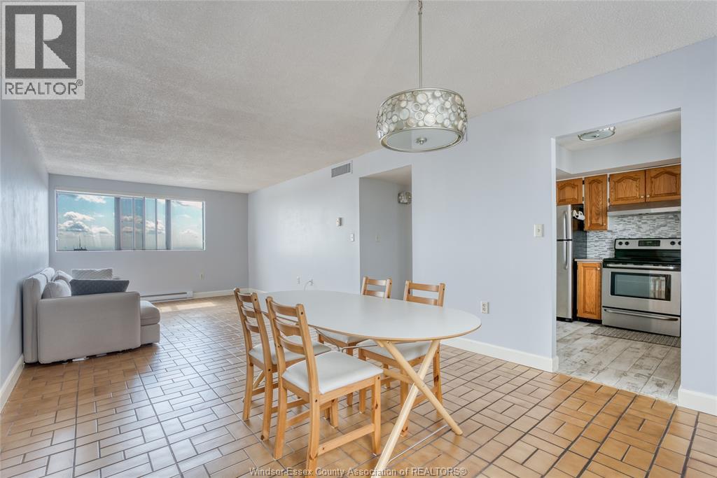 A dining room with a table and chairs.