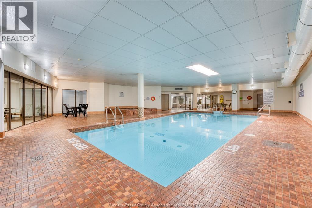A large indoor swimming pool with a tiled floor.