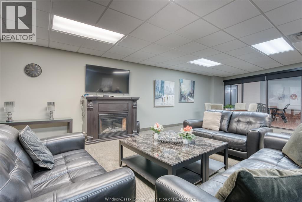 A living room with a grey leather couch and a coffee table.