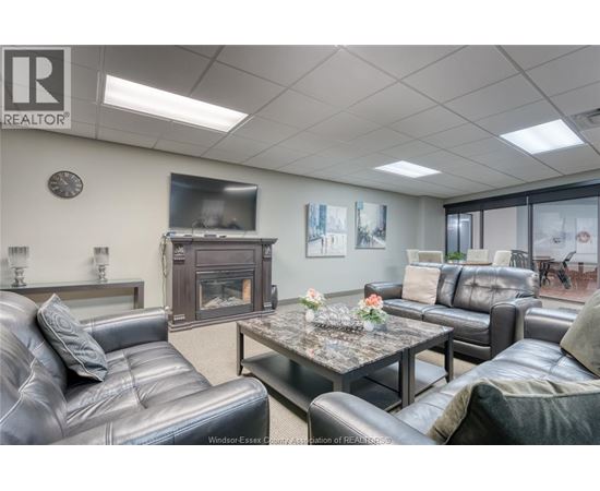 A living room with a grey leather couch and a coffee table.