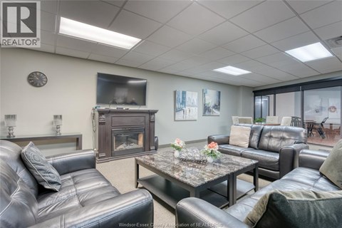 A living room with a grey leather couch and a coffee table.