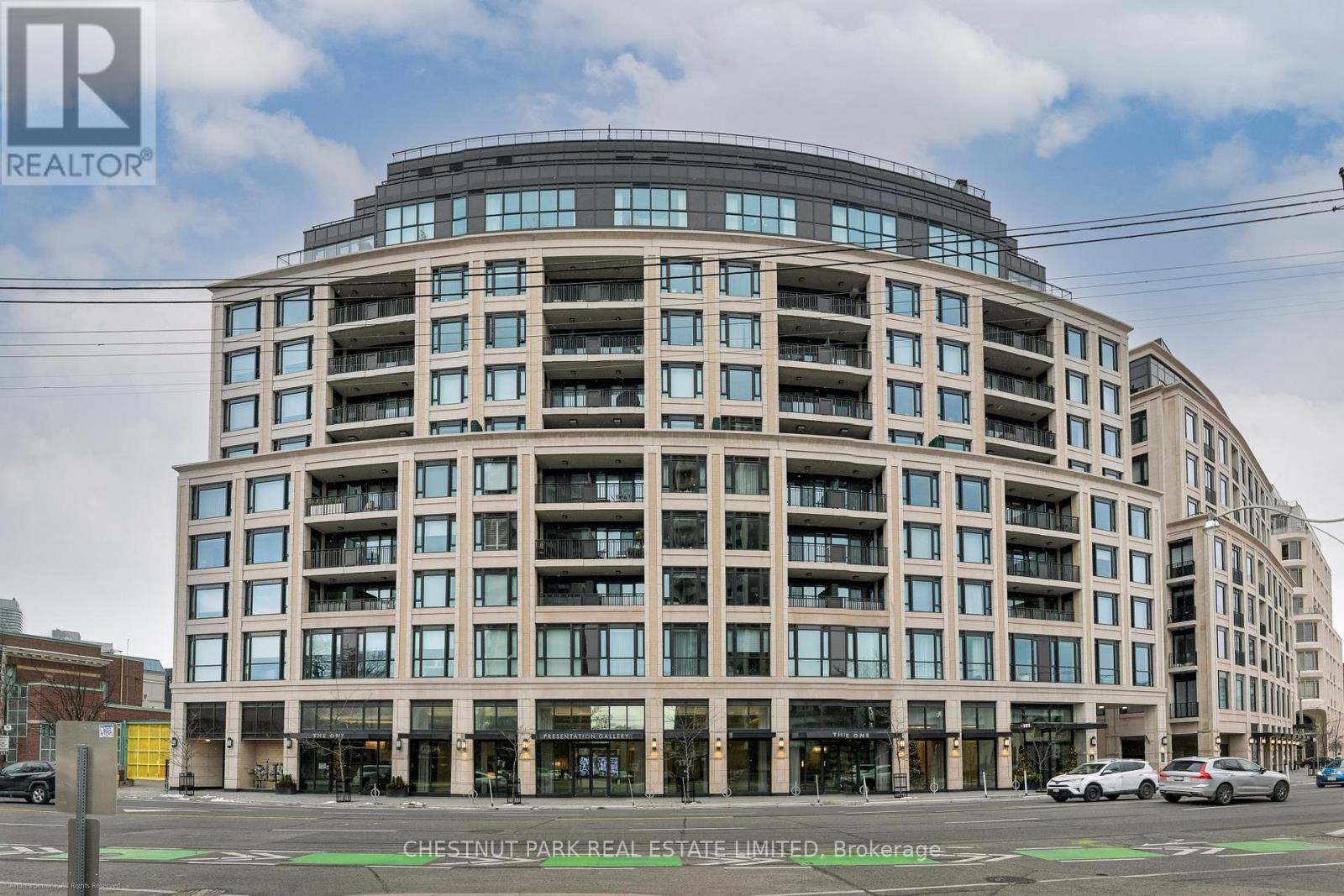 A large, modern building with many windows is the main focus of the image.