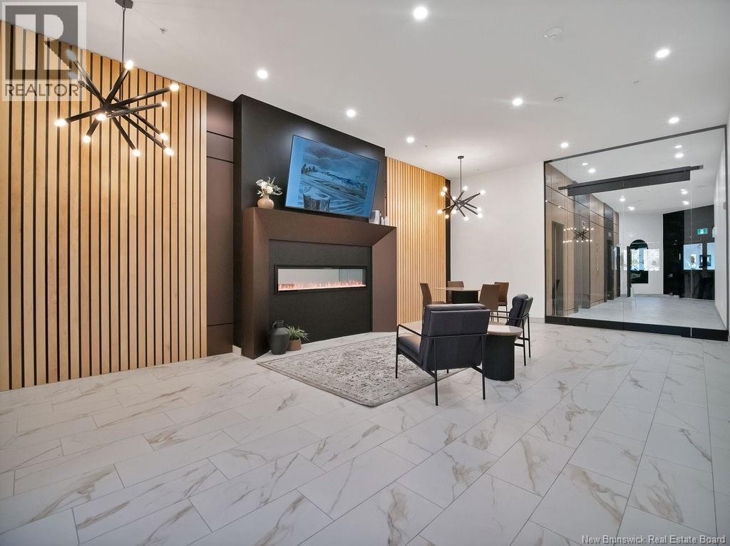 A modern living room with a fireplace and a painting on the wall.