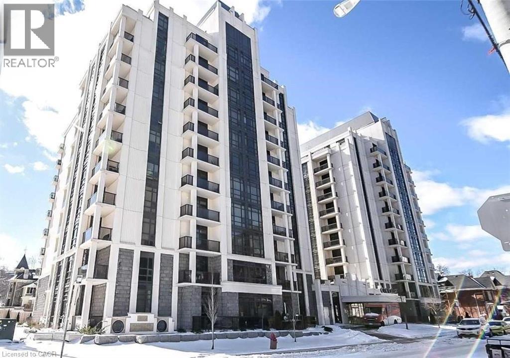 A tall white building with a glass facade stands in the snow.