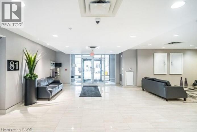 A well-lit, spacious lobby with a reception desk and seating area.