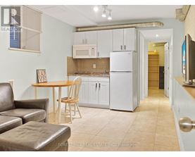 A kitchen with a table and chairs in the middle of the room.
