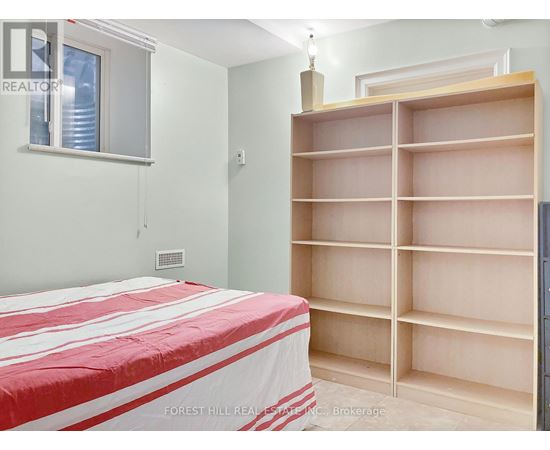 A bedroom with a large bed and a built-in bookshelf.