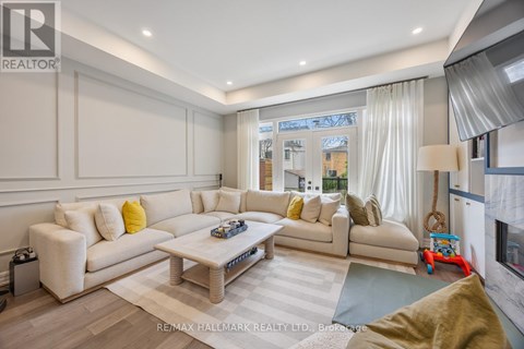 A living room with a white sofa and a coffee table.