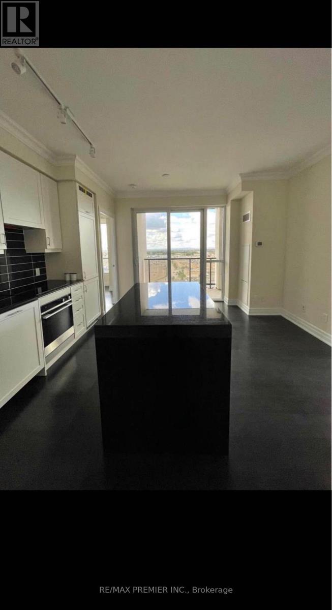 A black table in a white kitchen with a view of the balcony.