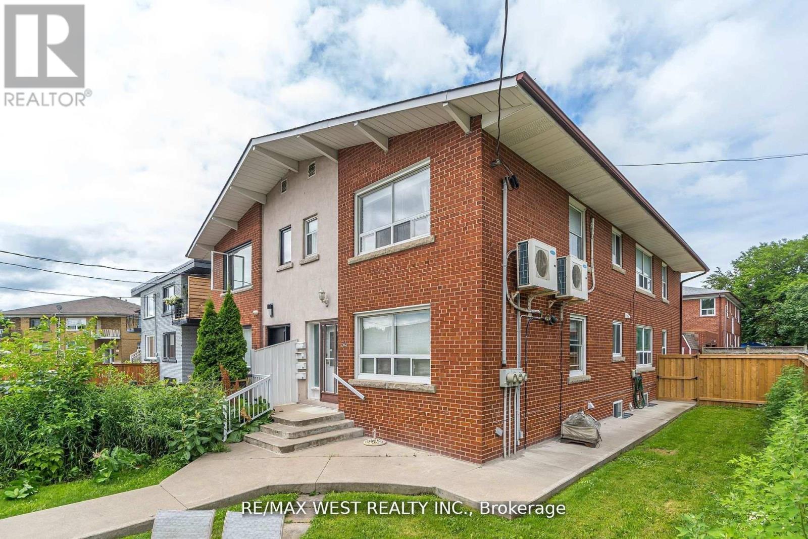 A house with a red brick exterior is for sale by RE/MAX West Realty Inc.