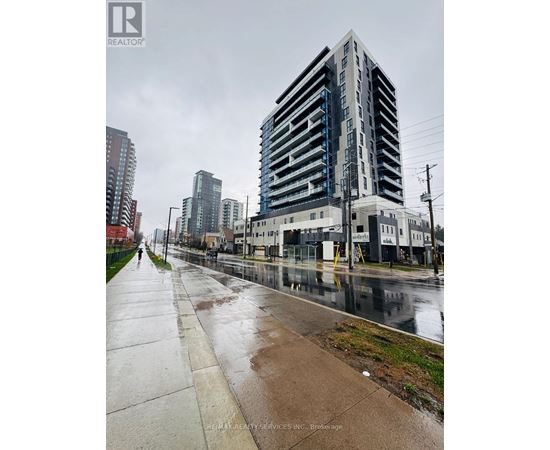 A tall building with a blue stripe on the side is in the background.