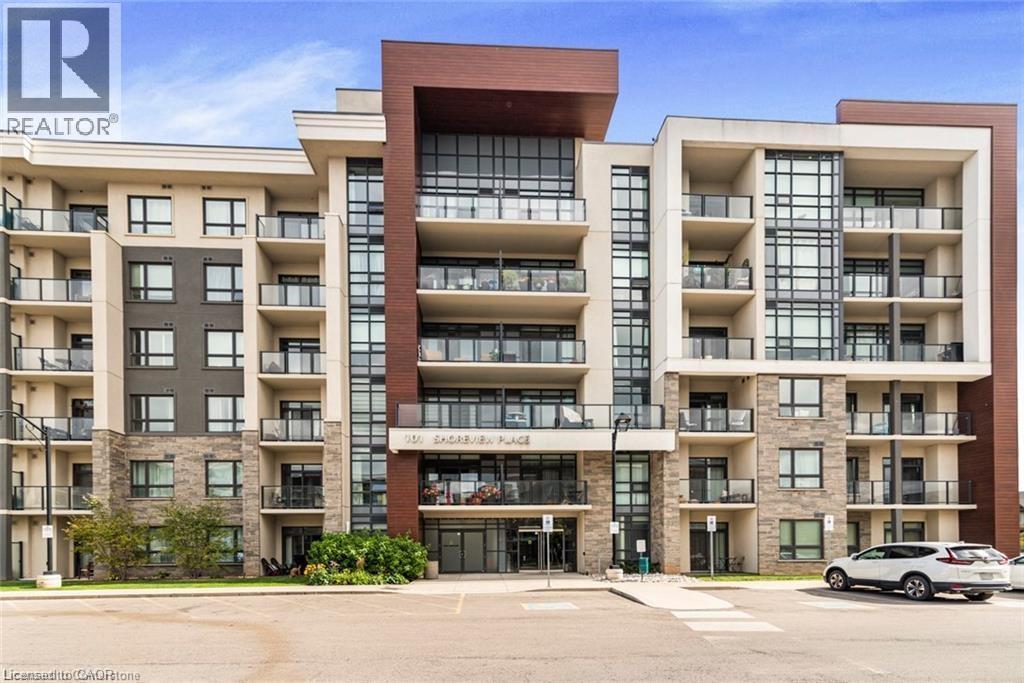 A large apartment building with a realtor logo on the top left.