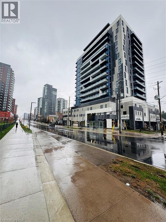 A city street with a tall building on the right.