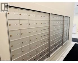 A row of metal mailboxes with numbers on them.
