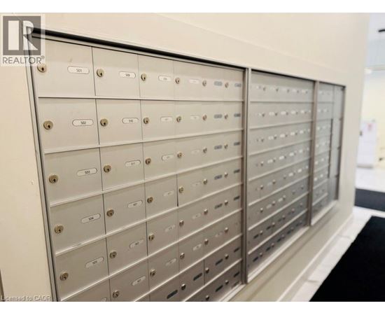 A row of metal mailboxes with numbers on them.