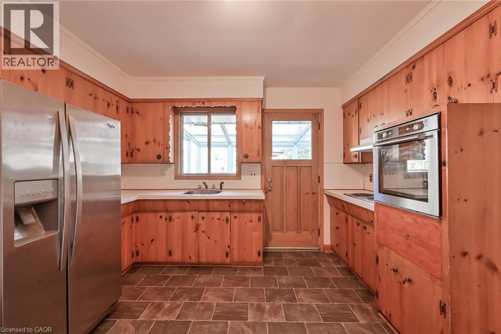 A kitchen with wooden cabinets and a refrigerator.