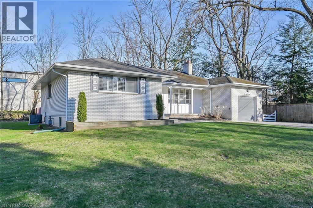 A house with a white and grey exterior is for sale.