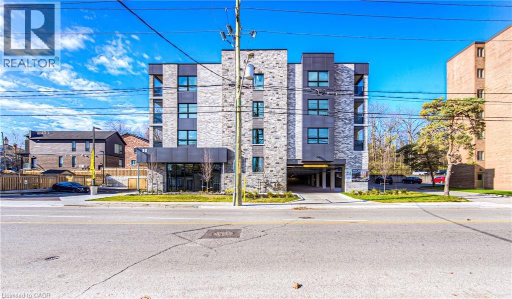 A modern apartment building with a clear blue sky above it.