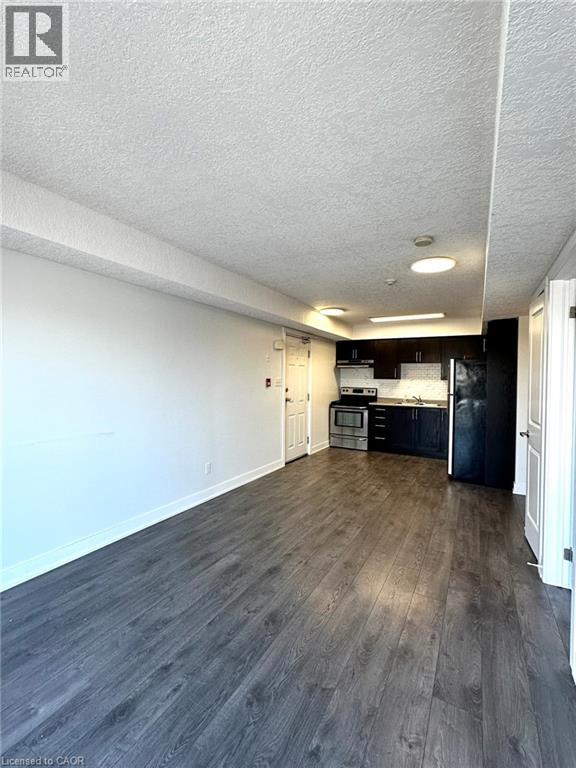 A kitchen with a refrigerator and a calendar on it.