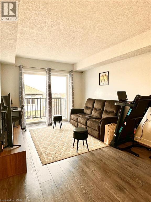 A living room with a brown couch and a television.