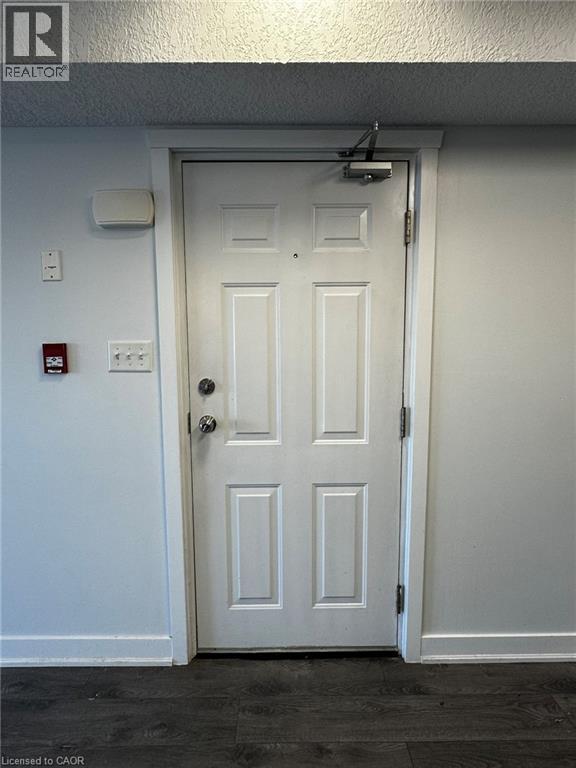 A bedroom with a bed, a fan, and a window.