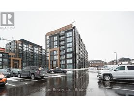A wet street scene with cars and buildings.